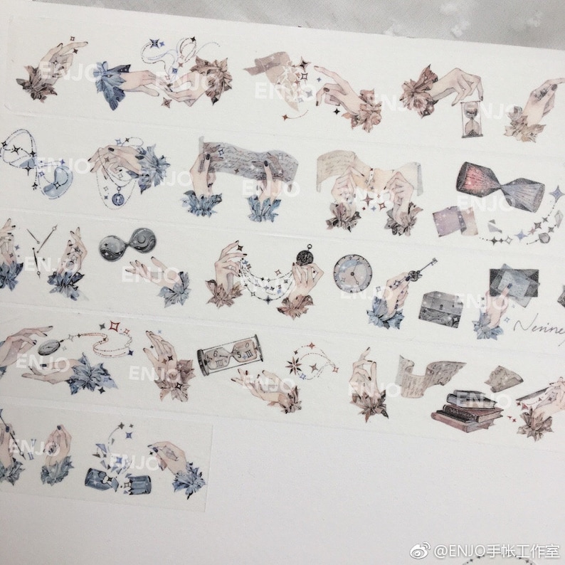 May include: A sheet of decorative washi tape featuring a variety of designs, including hands holding stars, clocks, and other objects. The tape is printed on a white background and has a watercolour effect.