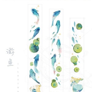 May include: Three rolls of washi tape featuring watercolor illustrations of blue fish, green leaves, and a woman in a blue dress. The tape is labeled "Neptune Studio" and "游鱼" which translates to "swimming fish".
