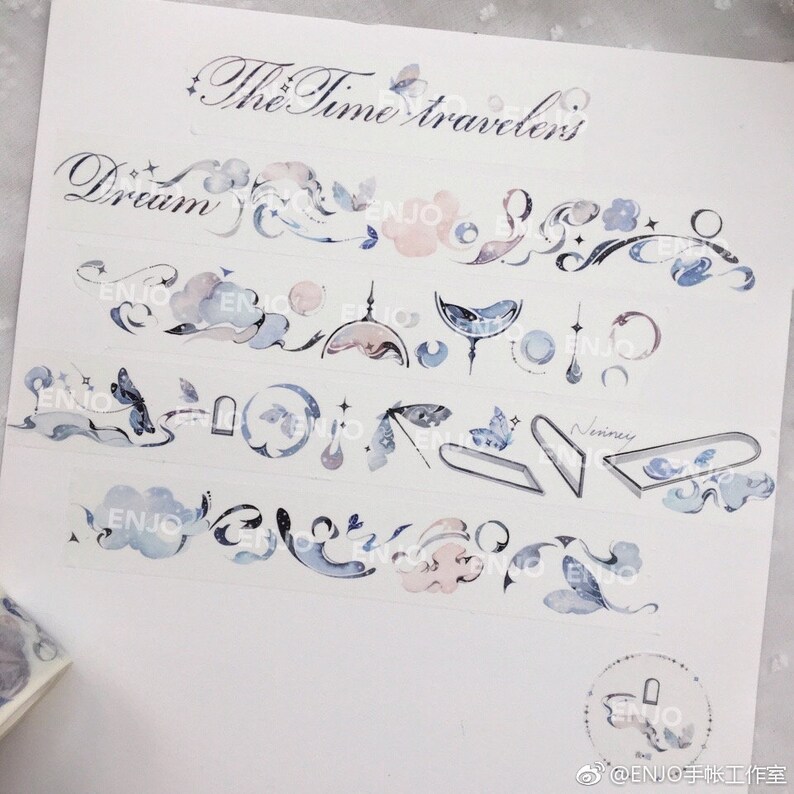 May include: A collection of decorative washi tapes featuring a whimsical watercolour design with clouds, stars, moons, butterflies, and the text "The Time Travelers" and "Dream".