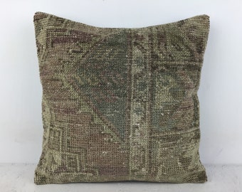 May include: A green and brown patterned throw pillow with a woven texture. The pillow is made from a soft, comfortable fabric and is perfect for adding a touch of bohemian style to your home.