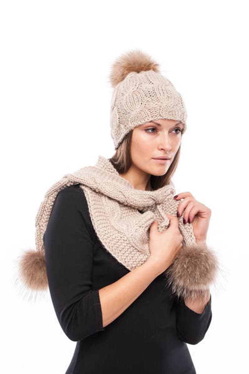 Handmade knitted beige wool hat with beige raccoon pom pom