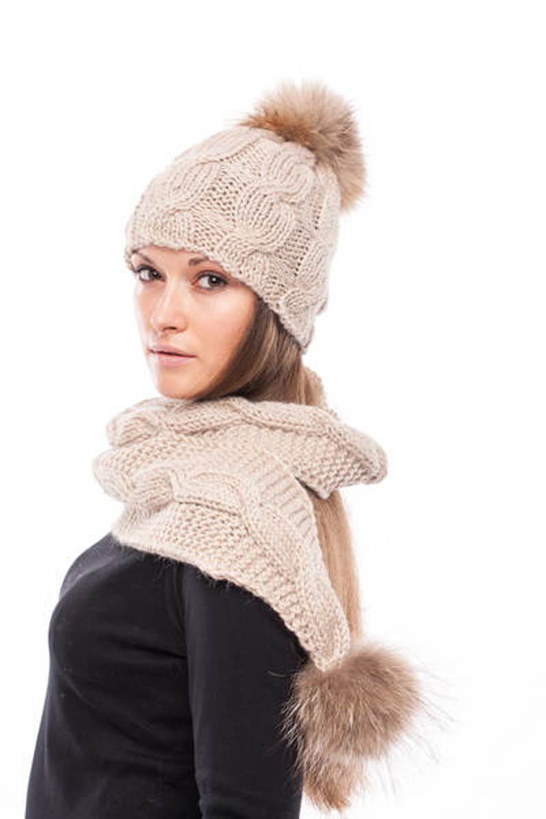 Handmade knitted beige wool hat with beige raccoon pom pom