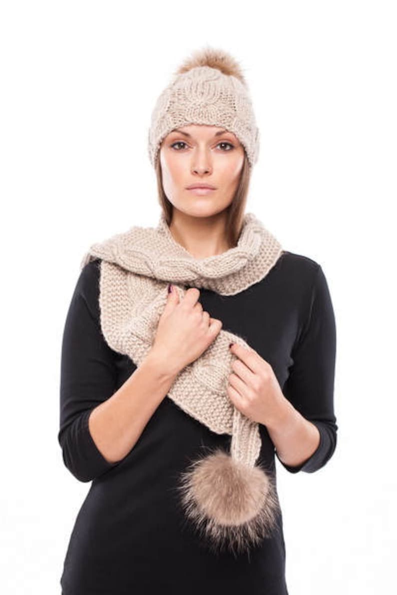 Handmade knitted beige wool hat with beige raccoon pom pom
