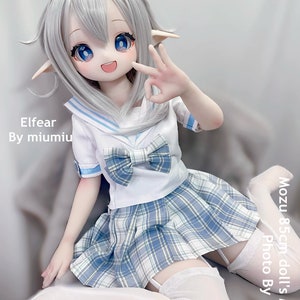 May include: A white doll with blue eyes and long silver hair wearing a white and blue sailor uniform with a plaid skirt and white thigh-high stockings. The doll is sitting on a white surface. The text "Elfear By miumiu" is visible in the image. The text "Mozu 85cm doll's Master Photo By" is also visible in the image.