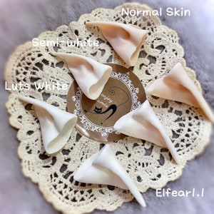 May include: Five pairs of elf ears in different shades of white, including normal skin, semi-white, and luts white. The ears are made of a soft, flexible material and are perfect for cosplay or costume use.