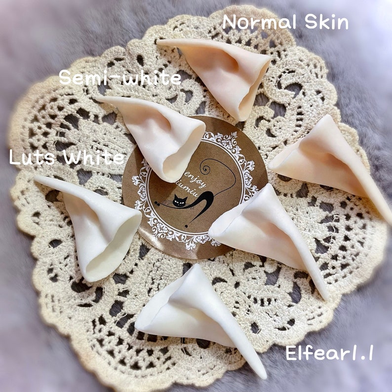 May include: Five pairs of elf ears in different shades of white, including normal skin, semi-white, and luts white. The ears are made of a soft, flexible material and are perfect for cosplay or costume use.