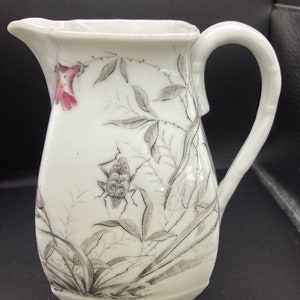Vintage ceramic/porcelain 6” creamer/pitcher with bugs and flowers.