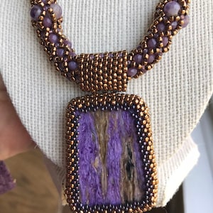 Purple stone pendant , beaded necklace.