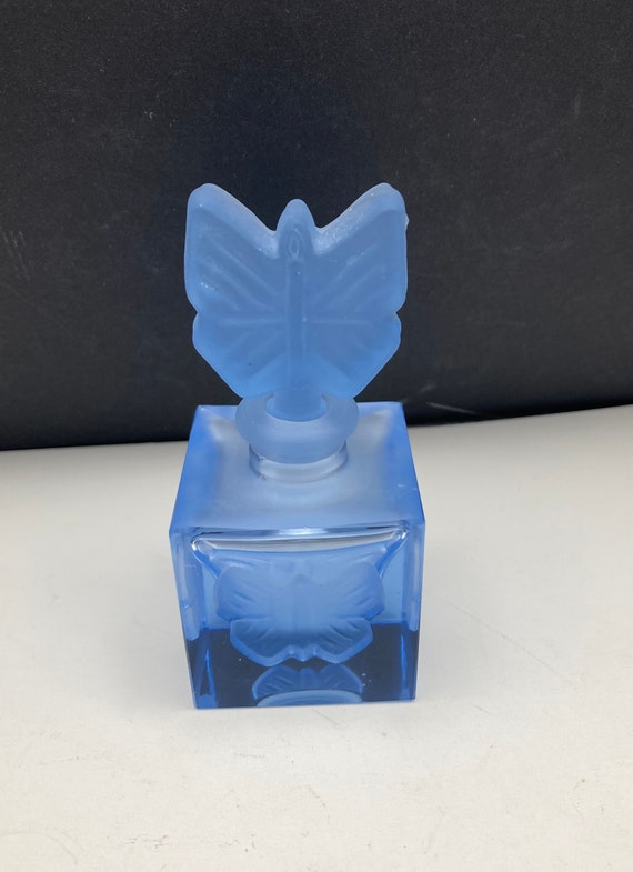 Blue frosted glass perfume bottle with butterflies