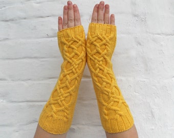 May include: A pair of yellow knitted fingerless gloves with a cable knit pattern.