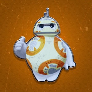 May include: A white and orange cartoon character with a round body and a single eye. The character is wearing a silver pin and has a friendly expression.