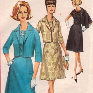 May include: A vintage sewing pattern for a dress and jacket. The pattern is for a half-size, size 20 1/2, with a bust size of 41. The pattern is from Simplicity and is printed in Canada. The pattern number is 5723.