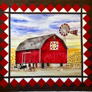 May include: A fabric quilt featuring a central scene of a red barn with a yellow and white quilt block pattern, a metal windmill, sunflowers, and three cows. The scene is framed by a dark brown border with a red and white diamond pattern.