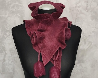May include: A burgundy felt neck warmer with ruffled edges and two dangling felt flower accents.