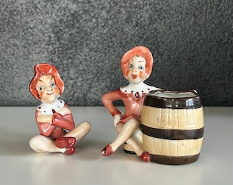 Pair of Occupied Japan Pixie / Elves - One with Barrel, One Sitting with Arms Crossed