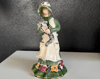 Blue Sky Clayworks “Ashley” Figurine - Girl in Green Dress, Apron, and Bonnet Holding a Cat - Heather Goldminc