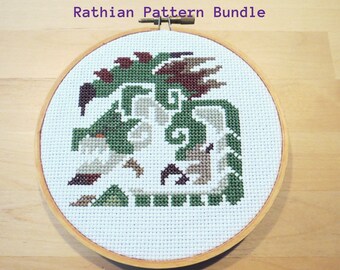May include: A cross-stitch embroidery hoop with a green, brown, and white design of a Rathin dragon. The text "Rathin Pattern Bundle" is above the hoop and "Standard, Pink, and Gold Rathin" is below the hoop.