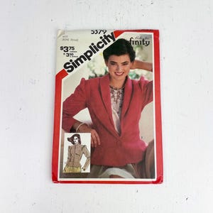 May include: A vintage Simplicity sewing pattern showing a woman in a red blazer. The pattern includes a smaller image of a different blazer design. The text on the pattern includes "Miss Jeune Femme" and the Simplicity logo.