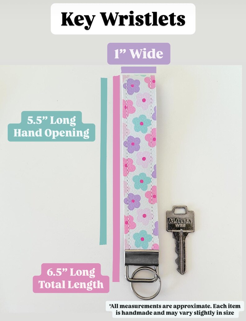 May include: A pink and white key wristlet with a floral pattern. The wristlet is 1 inch wide, 5.5 inches long for the hand opening, and 6.5 inches long total. The wristlet has a silver key ring and a silver key.