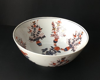 Beau grand bol en porcelaine conçu avec des jardinières florales bleues et orange brûlé avec plusieurs plantes dans un vase