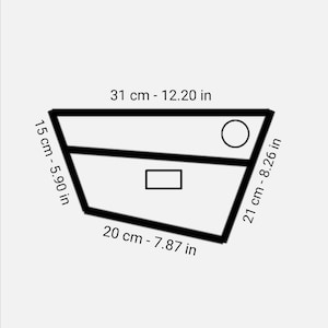 May include: A black and white line drawing of a geometric shape with measurements in inches and centimeters. The shape is a trapezoid with a circle and a rectangle inside.