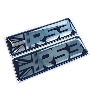 May include: Two black and silver 3D resin stickers with the text "RSB" and a Union Jack design.