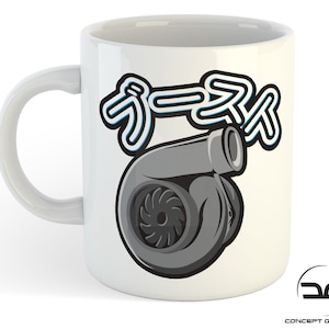 May include: White ceramic mug featuring a black and grey turbocharger graphic and the Japanese word "Boost" in blue and white lettering.