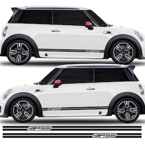 May include: White Mini Cooper with black racing stripes and the word "SASS" on the side. The car has black wheels and a black spoiler.