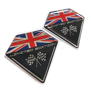 May include: Two black diamond-shaped decals with a Union Jack flag design and the text "LIMITED EDITION" in silver lettering. Each decal also features a pair of crossed checkered racing flags.