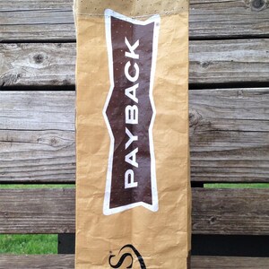 May include: A brown paper bag with a white logo that says "CHS" and a brown and white logo that says "PAYBACK".