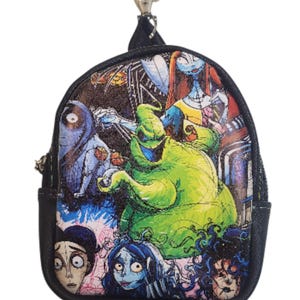 May include: A small, black, round coin purse with a zipper and a silver-colored clasp. The front of the purse features a colorful illustration of characters from The Nightmare Before Christmas, including Oogie Boogie and Sally.