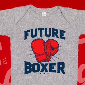 May include: Gray baby onesie with the text "FUTURE BOXER" in blue and a red boxing glove graphic.
