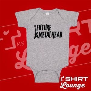 May include: Gray baby onesie with black text that reads "FUTURE METALHEAD" and a graphic of two electric guitars.