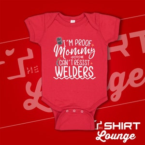 May include: Red baby onesie with white text that reads "I'm proof mommy can't resist welders". The onesie has a small welding mask graphic.