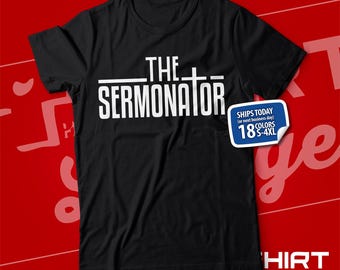 May include: Black t-shirt with white text that reads "THE SERMONATOR" with a cross symbol above the word "SERMONATOR".