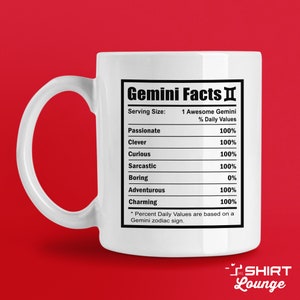 May include: White ceramic mug with a black graphic of a nutrition facts label for Geminis. The label lists traits like passionate, clever, curious, sarcastic, boring, adventurous, and charming, with percentages for each.