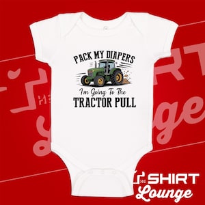 May include: A white short-sleeved baby bodysuit featuring a graphic of a green tractor with yellow wheels. The text above the tractor reads PACK MY DIAPERS and the text below reads I'm Going To The TRACTOR PULL in black lettering.