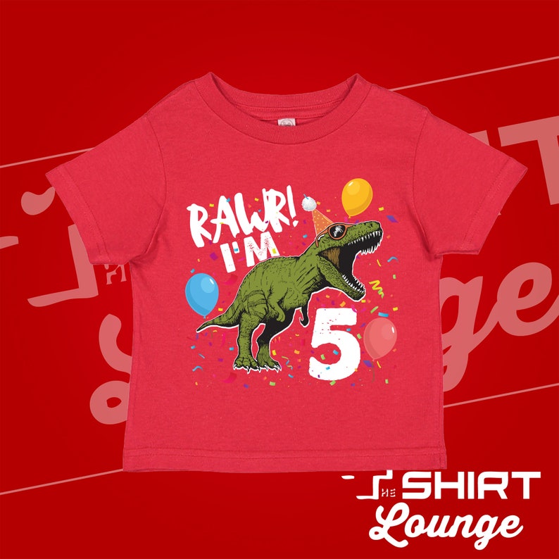 May include: Red short-sleeved t-shirt with a green dinosaur wearing a party hat and sunglasses. The dinosaur is saying "Rawr! I'm 5" with confetti and balloons around it.