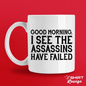 Taza de café divertida: Taza novedosa con el sarcasmo "Buenos días, asesinos"