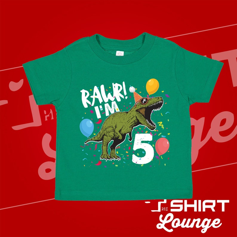 May include: Green t-shirt with a green dinosaur wearing a party hat and sunglasses. The dinosaur is holding a balloon and the text "Rawr! I'm 5" is printed on the shirt.