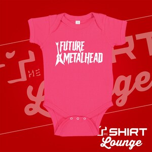 May include: Pink baby onesie with a white graphic of a guitar and the text "FUTURE METALHEAD".