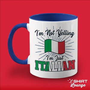 May include: White ceramic mug with a blue rim and handle. The mug has a design of the Italian flag with the text "I'm Not Yelling I'm Just ITALIAN".