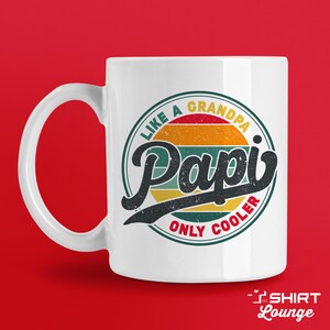 May include: White ceramic mug with a colorful retro-style design. The design features a circle with the text "Like a Grandpa, Only Cooler" and the word "Papi" in a large, stylized font.