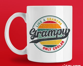May include: White ceramic mug featuring a colourful retro-style graphic that reads "Like a Grandpa, Only Cooler" with the word "Grampa" in a large, stylised font.