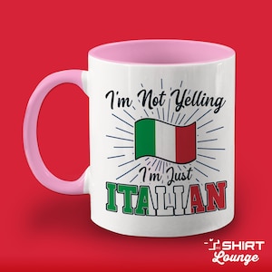 May include: White ceramic mug with a pink rim and handle. The mug has a design featuring the Italian flag and the text "I'm Not Yelling I'm Just ITALIAN".