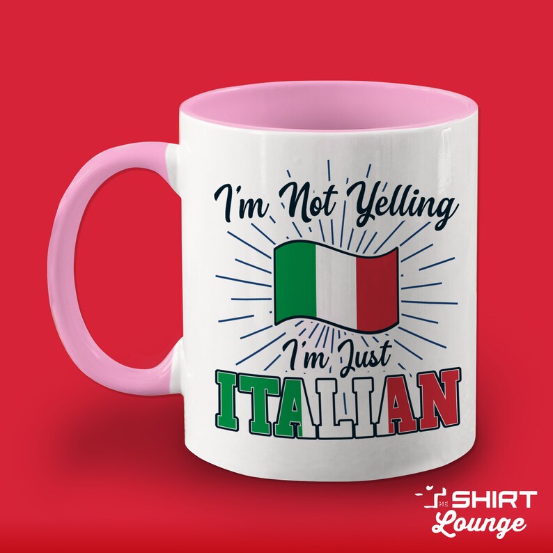 May include: White ceramic mug with a pink rim and handle. The mug has a design featuring the Italian flag and the text "I'm Not Yelling I'm Just ITALIAN".