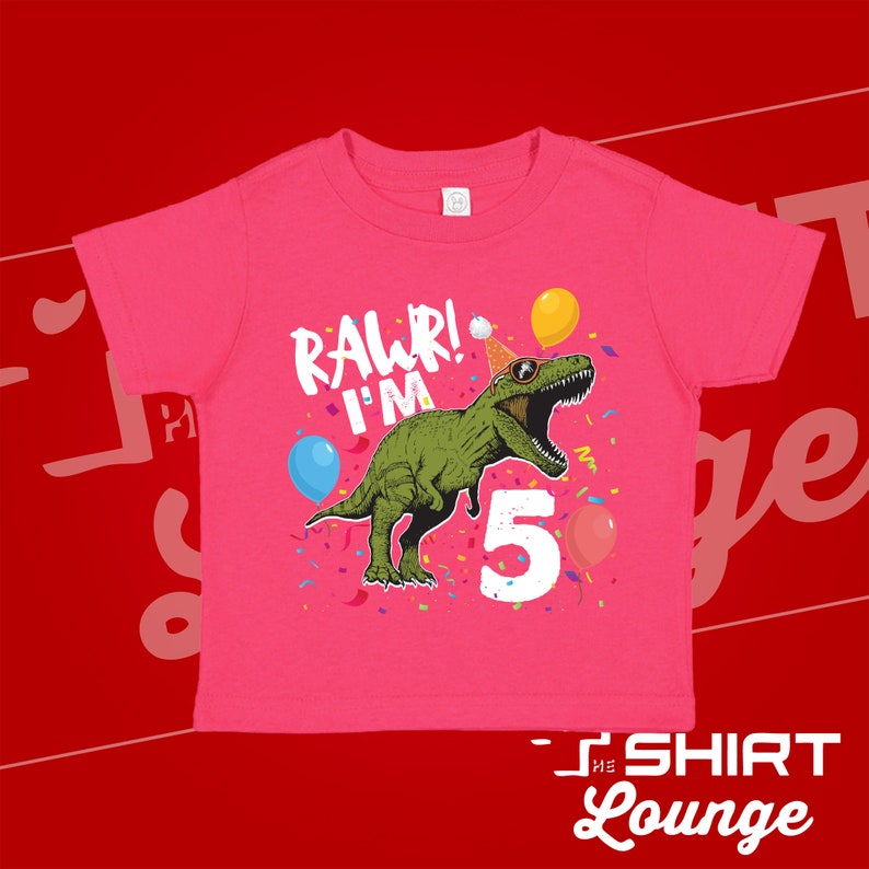 May include: Pink toddler t-shirt with a green dinosaur wearing a party hat and sunglasses. The dinosaur is saying "Rawr! I'm 5" with confetti and balloons around it.