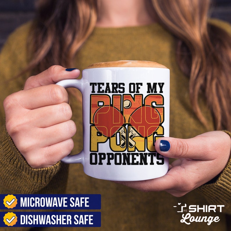 May include: White ceramic coffee mug with a retro design featuring the text "Tears of my ping pong opponents". The mug is microwave and dishwasher safe.