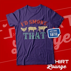 May include: Purple t-shirt with the text "I'd Smoke That" in a vintage style font. The text is surrounded by images of a chicken, pig, and cow.