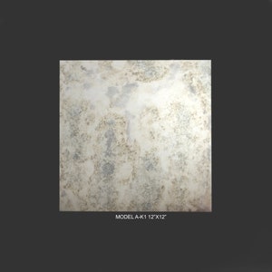 May include: A close-up of a distressed, antique-looking mirror tile. The tile has a white background with brown and grey markings. The tile is 12 inches by 12 inches. The text "MODEL A-K1 12"X12"" is printed below the tile.